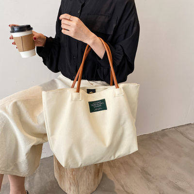 Dernière mode Logo personnalisé toile Poche grande capacité étudiant sac à main unique